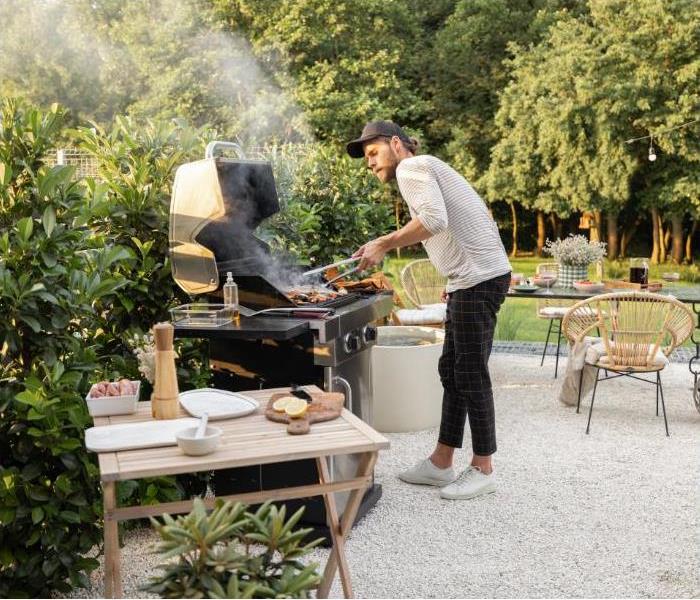 man cooking in outdoor grill barbequw